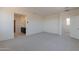 Bright bedroom with grey carpet and access to a bathroom at 35775 N Zinc Dr, San Tan Valley, AZ 85144