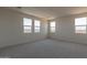 Large bedroom with grey carpet and multiple windows at 35775 N Zinc Dr, San Tan Valley, AZ 85144