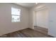 Spacious bedroom featuring a large window and wood-look floors at 35775 N Zinc Dr, San Tan Valley, AZ 85144