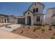 Two-story home with gray garage door and landscaped yard at 35775 N Zinc Dr, San Tan Valley, AZ 85144