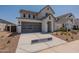 Two-story home with gray garage door and landscaped yard at 35775 N Zinc Dr, San Tan Valley, AZ 85144