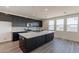 Modern kitchen with dark cabinets, white quartz countertops and stainless steel appliances at 35775 N Zinc Dr, San Tan Valley, AZ 85144