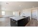 Modern kitchen island with a breakfast bar and white countertop at 35775 N Zinc Dr, San Tan Valley, AZ 85144