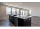 Kitchen island with a large quartz countertop and modern sink at 35775 N Zinc Dr, San Tan Valley, AZ 85144