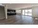 Living area with sliding doors to backyard, gray flooring, and modern kitchen at 35775 N Zinc Dr, San Tan Valley, AZ 85144