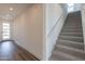 Modern staircase with gray carpeting and hardwood floors at 35775 N Zinc Dr, San Tan Valley, AZ 85144