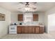 Kitchen with wood cabinets, white appliances, and tiled floor at 3640 W Garfield St, Phoenix, AZ 85009