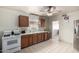 View of kitchen with wood cabinets, white appliances, and tile floor at 3640 W Garfield St, Phoenix, AZ 85009