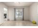 Spare bedroom with tiled floor, window, and view of backyard at 3640 W Garfield St, Phoenix, AZ 85009