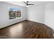 Bright bedroom featuring hardwood floors and a large window with natural light at 3835 E Kent Dr, Phoenix, AZ 85044