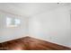 Simple bedroom with wood-look flooring and a window at 4303 W Solano N Dr, Glendale, AZ 85301