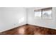 Simple bedroom with wood-look flooring and a large window at 4303 W Solano N Dr, Glendale, AZ 85301