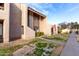 Two-story stucco townhome with a walkway and grassy area at 4303 W Solano N Dr, Glendale, AZ 85301