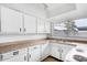 White kitchen features ample counter space and cabinets at 4303 W Solano N Dr, Glendale, AZ 85301