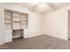 Bedroom with built-in shelves, desk, and ceiling fan at 4532 E Sandra Ter, Phoenix, AZ 85032