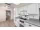 White kitchen with appliances and view to dining room at 4532 E Sandra Ter, Phoenix, AZ 85032