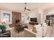 Spacious living room featuring a brick fireplace and large TV at 4532 E Sandra Ter, Phoenix, AZ 85032