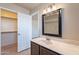 Bathroom with vanity, large mirror and closet access at 470 E Echo Ln, Florence, AZ 85132