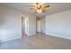 Well lit bedroom with ceiling fan and access to hallway at 470 E Echo Ln, Florence, AZ 85132