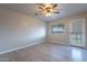 Bedroom with door leading to backyard and ceiling fan at 470 E Echo Ln, Florence, AZ 85132