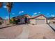 Single-story house with a two-car garage and a landscaped front yard at 470 E Echo Ln, Florence, AZ 85132