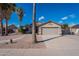 House exterior with garage, walkway, and palm trees at 470 E Echo Ln, Florence, AZ 85132