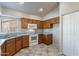 Kitchen with oak cabinets, tile flooring, and white appliances at 470 E Echo Ln, Florence, AZ 85132