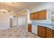 Open kitchen with oak cabinets, tile floor, and view of dining area at 470 E Echo Ln, Florence, AZ 85132