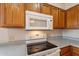 Close up of kitchen appliances including a microwave and range at 470 E Echo Ln, Florence, AZ 85132