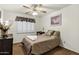 Relaxing bedroom with ceiling fan and white shutters providing ample natural light at 4762 E Pawnee Cir, Phoenix, AZ 85044