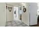 Bright hallway with neutral paint and tile floors leading into other rooms of the home at 4762 E Pawnee Cir, Phoenix, AZ 85044