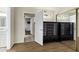 Hallway between rooms with a large decorative cabinet and a mirrored closet at 4762 E Pawnee Cir, Phoenix, AZ 85044