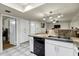 Kitchen with stainless steel sink, black dishwasher, and view to living area at 4762 E Pawnee Cir, Phoenix, AZ 85044