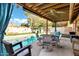 Relaxing covered patio overlooking the pool, complete with an outdoor dining set at 4762 E Pawnee Cir, Phoenix, AZ 85044