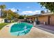 Inviting backyard pool with a covered patio, perfect for outdoor relaxation and entertaining at 4762 E Pawnee Cir, Phoenix, AZ 85044