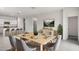 Bright dining area with a wood table and six grey chairs at 4929 S 105Th Ln, Tolleson, AZ 85353