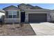 Single-story home with two-car garage and desert landscaping at 4929 S 105Th Ln, Tolleson, AZ 85353