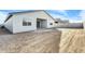 New construction backyard awaiting landscaping; covered patio for outdoor living, cinder block fence on neighbors at 5030 W Hunter Trl, San Tan Valley, AZ 85144