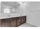 Double vanity bathroom with modern dark brown cabinets at 5030 W Hunter Trl, San Tan Valley, AZ 85144