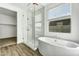 Beautiful bathroom featuring a soaking tub and frameless shower at 5030 W Hunter Trl, San Tan Valley, AZ 85144