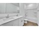 Bathroom featuring a dual sink vanity and tub/shower combo at 5030 W Hunter Trl, San Tan Valley, AZ 85144