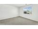 Bright bedroom featuring neutral carpeting, fresh paint, and a window at 5030 W Hunter Trl, San Tan Valley, AZ 85144