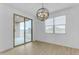 Dining area with sliding glass door to the patio and a chandelier at 5030 W Hunter Trl, San Tan Valley, AZ 85144