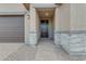 Front entry with stonework and a dark brown door at 5030 W Hunter Trl, San Tan Valley, AZ 85144