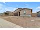 Front view of a tan house with a two-car garage at 5030 W Hunter Trl, San Tan Valley, AZ 85144