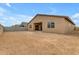 Tan house exterior with a covered patio and large backyard at 5030 W Hunter Trl, San Tan Valley, AZ 85144