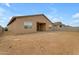 Tan house exterior with a covered patio and large backyard at 5030 W Hunter Trl, San Tan Valley, AZ 85144