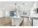 Modern kitchen featuring white cabinets, stainless steel appliances, and a large center island with a sink at 5030 W Hunter Trl, San Tan Valley, AZ 85144