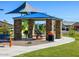 Park pavilion with stone pillars, shade cover, grill, and picnic table at 5030 W Hunter Trl, San Tan Valley, AZ 85144