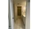 A neutral-toned bathroom featuring a white vanity, tile floor, and tub with dark tile surround at 5035 N 17Th Ave # 206, Phoenix, AZ 85015